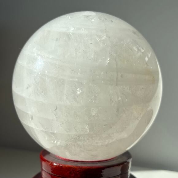 Large Milky Clear Quartz Sphere | Crystal Ball with Wispy Striped Inclusions - Picture 3 of 9